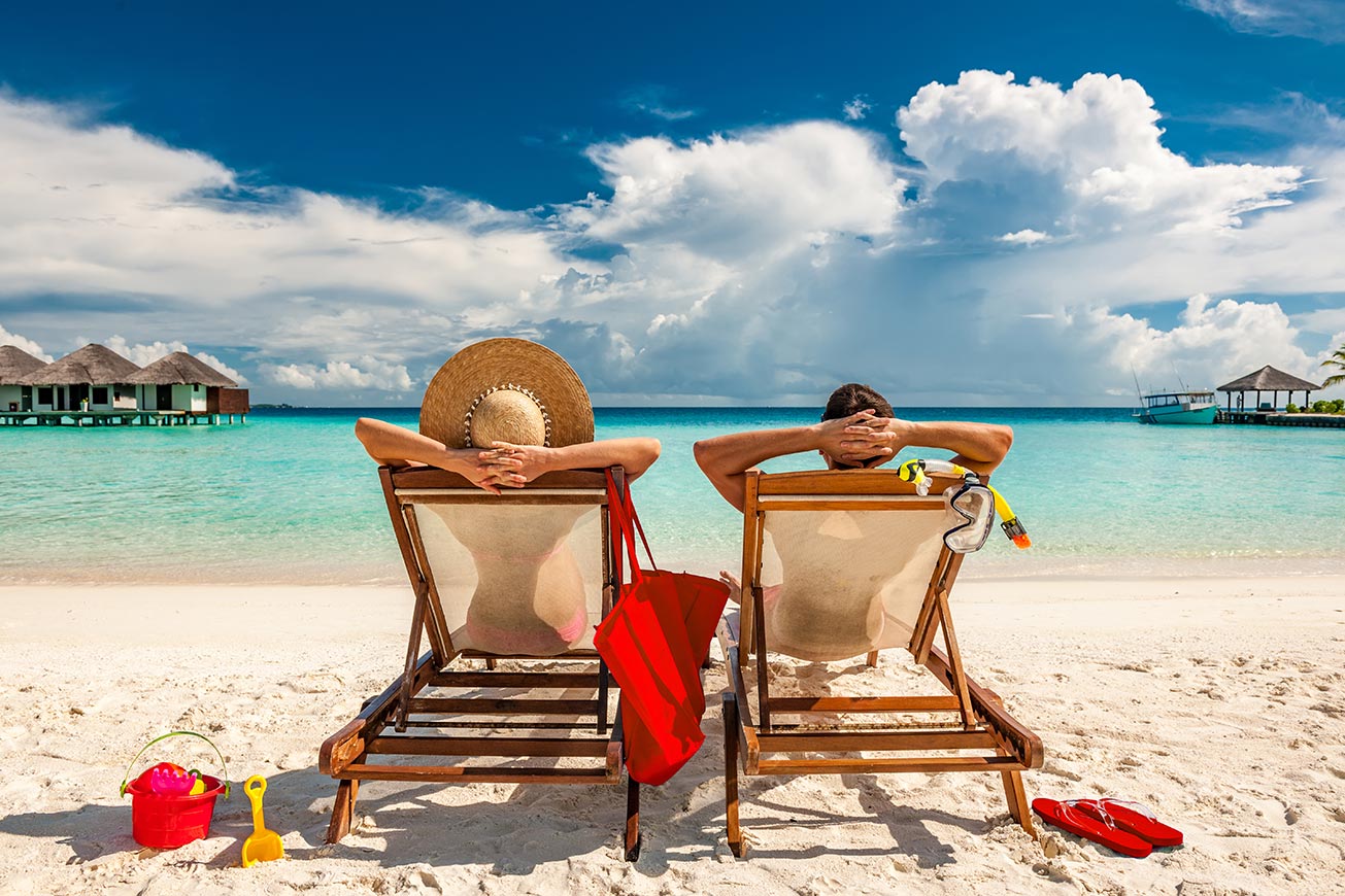 couple-in-loungers-on-the-beach.jpg